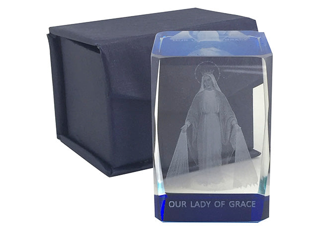 Clear glass display case with 'Our Lady of Grace' engraving, featuring a religious figure, on a white background.